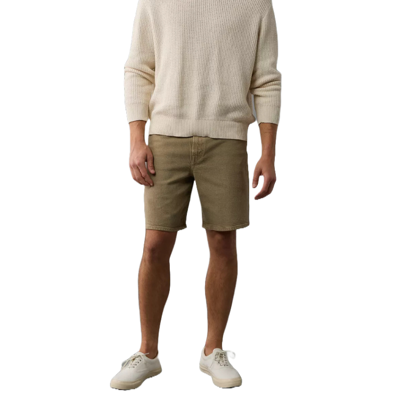 EasyFlex Loose Denim Short in light brown features a relaxed fit, ending just above the knee, paired with a cream sweater and white sneakers, creating a casual, comfortable look.