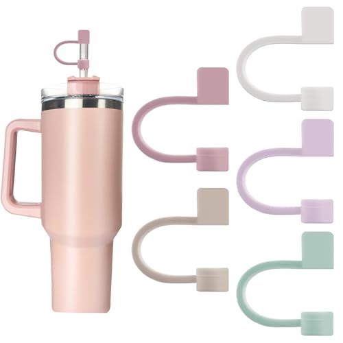 Five silicone straw toppers in pastel shades of pink, purple, and green are displayed, each with an attached rectangular tab, alongside a pink insulated tumbler with one of the toppers in use.