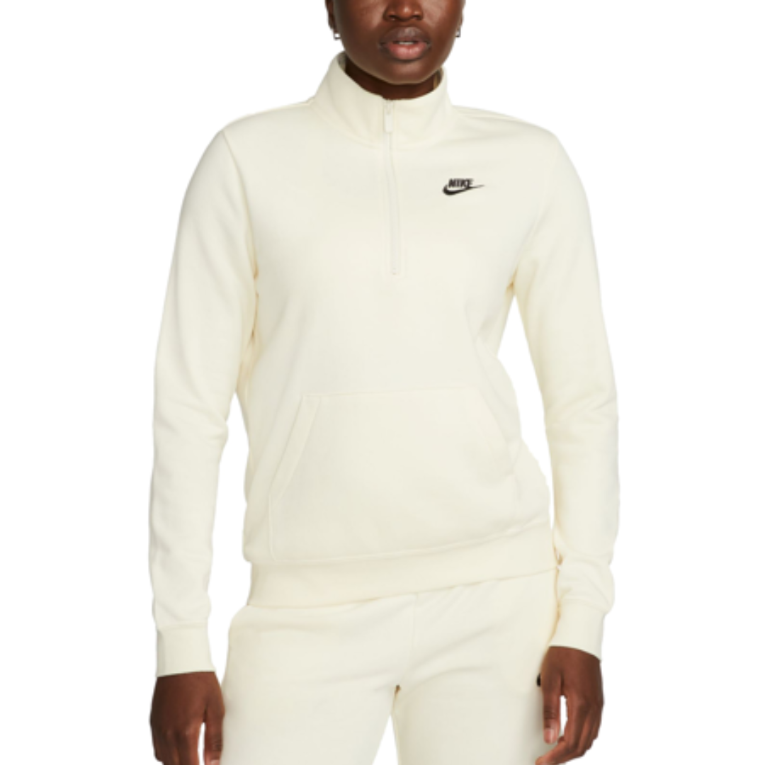 A cream-colored Nike pullover with a quarter-zip, featuring the brand logo on the chest. The outfit includes matching pants, creating a coordinated look.