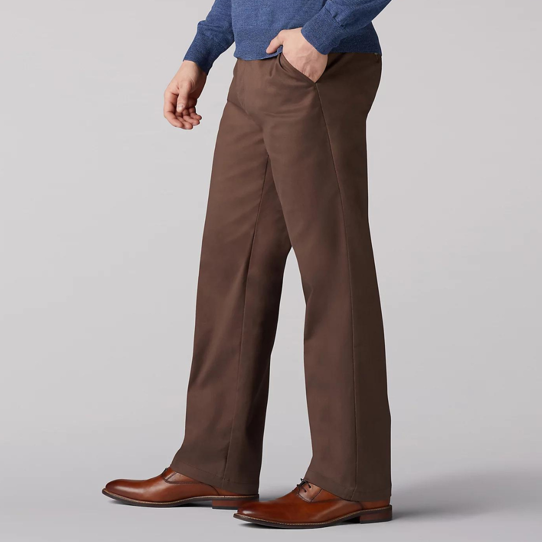 A pair of brown dress pants and brown leather shoes worn by a person.