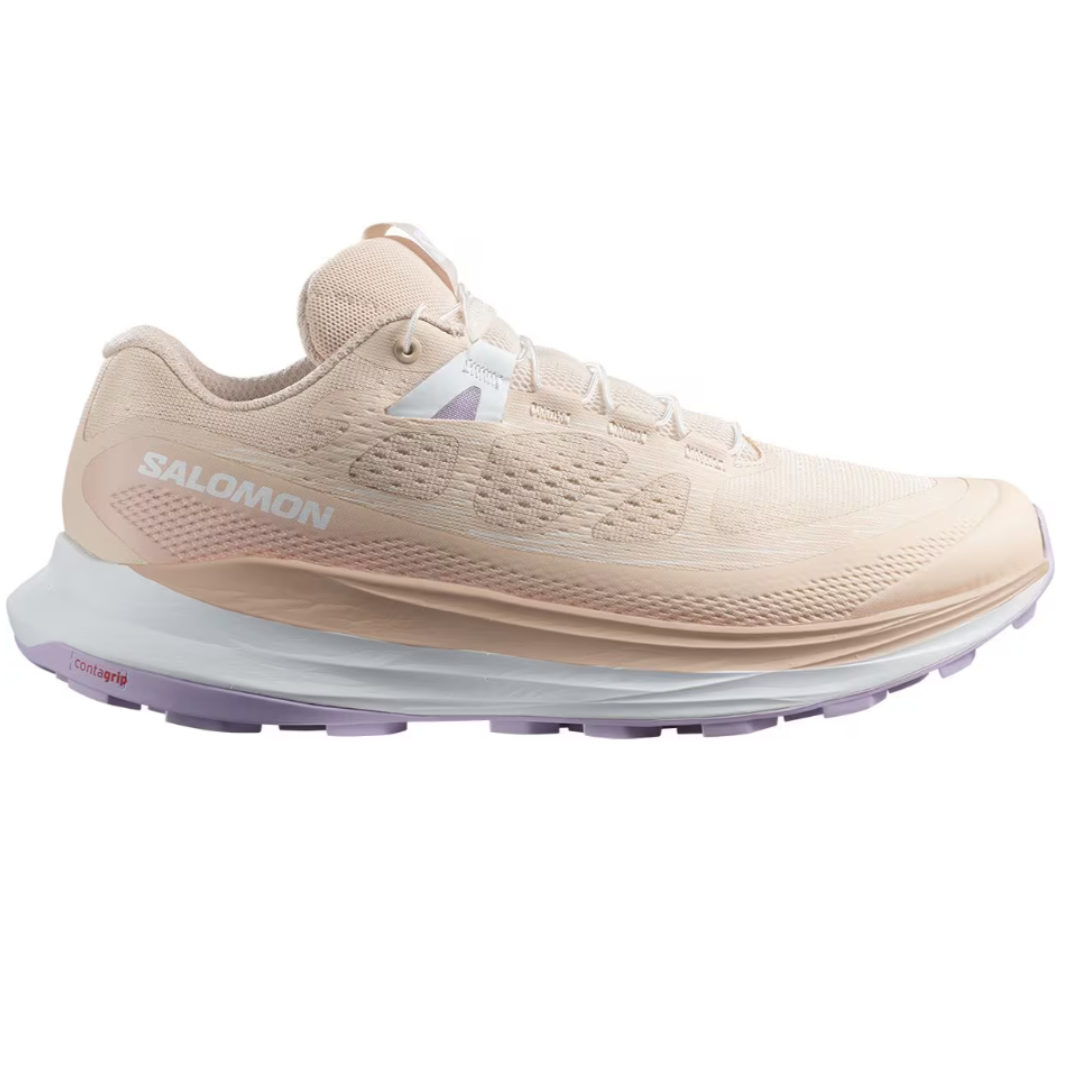 A cream-colored Salomon running shoe with a thick sole and branding on the side.