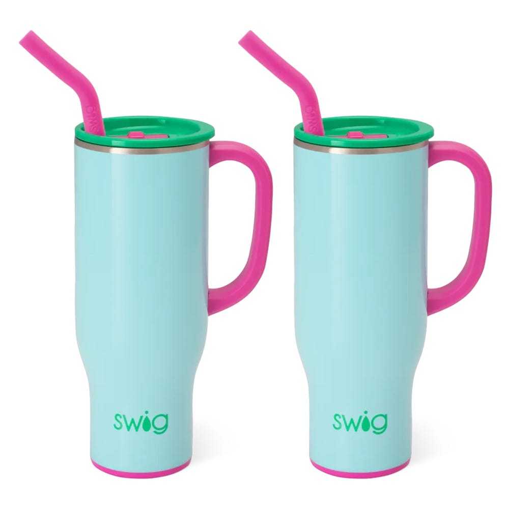 Two pastel blue mugs with pink handles and straws, and green lids.