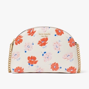 A floral-patterned, dome-shaped cosmetic bag with a gold chain detail.