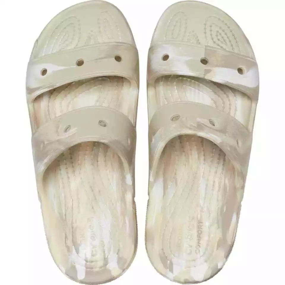 A pair of translucent beige rubber sandals with a textured insole design.