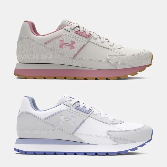 Two pairs of Under Armour sneakers, one with grey and pink accents, the other all-white with a hint of blue on the sole.