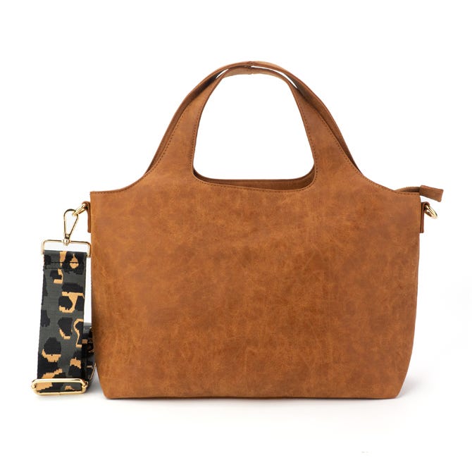 A brown faux-leather tote bag with two handles and a detachable strap featuring a camouflage pattern. The bag has a clean, structured design with gold hardware accents.