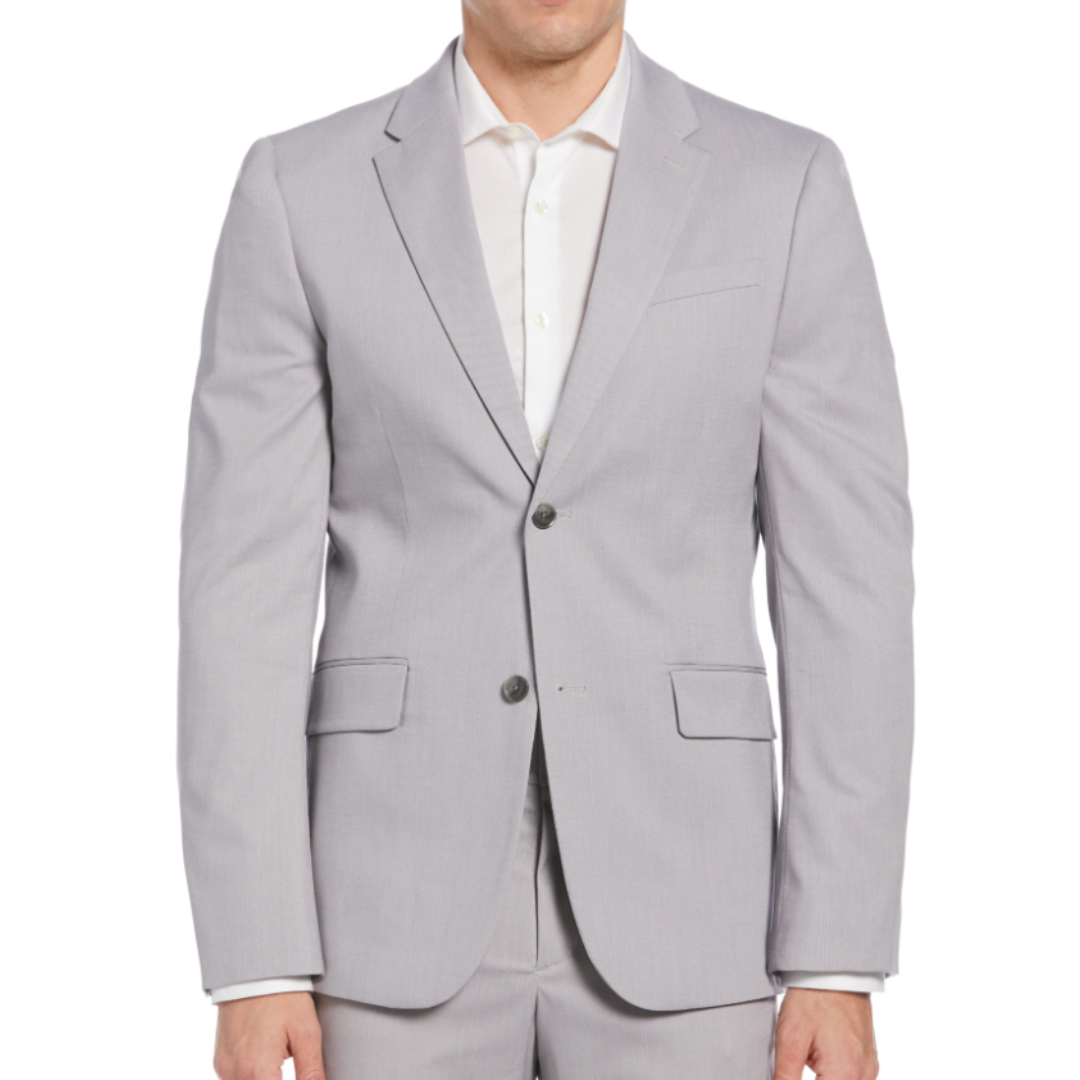 A man is wearing a light gray suit with a white dress shirt. The suit jacket features notched lapels, a two-button closure, and flap pockets.