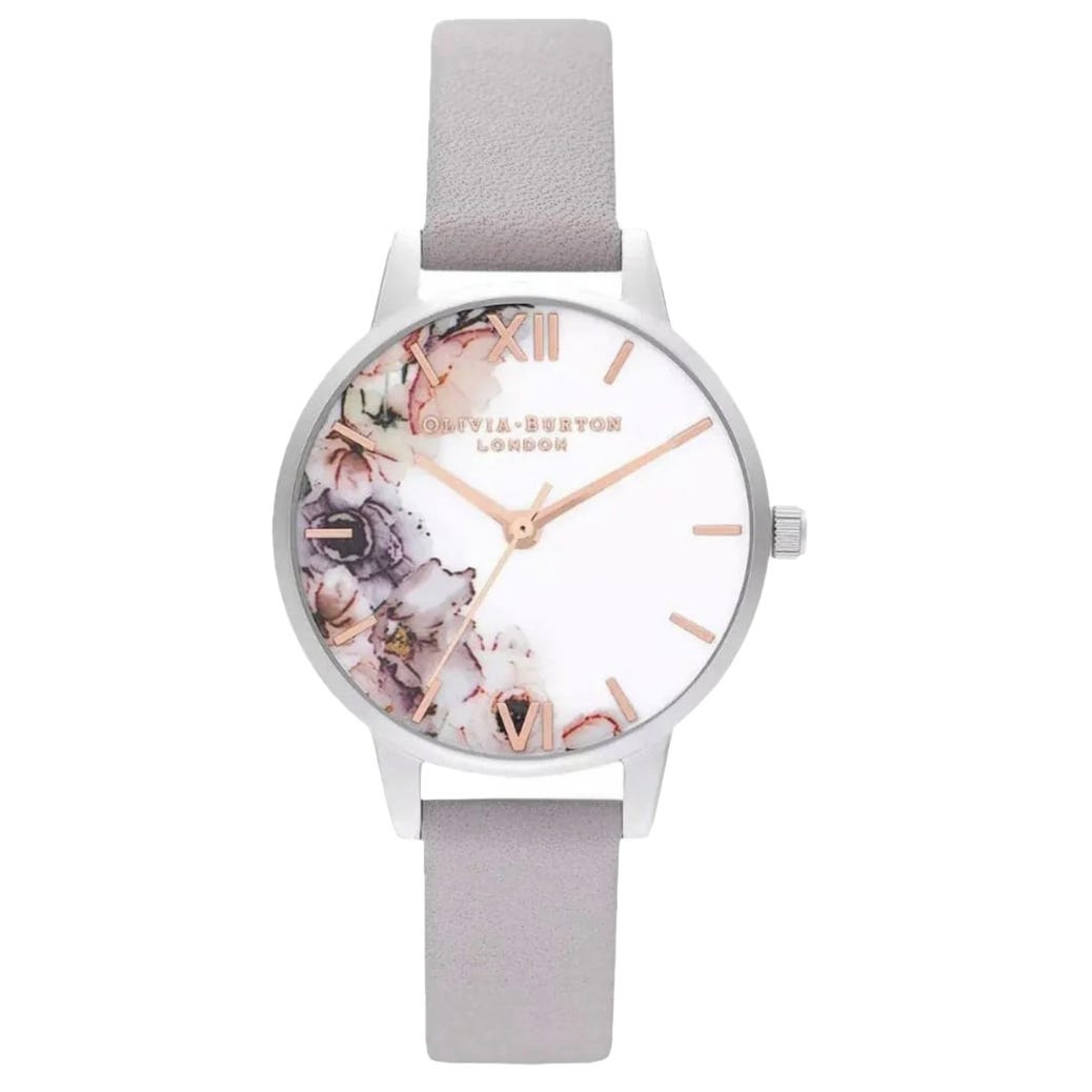 A stylish Olivia Burton watch featuring a light grey leather strap, silver casing, and a floral design on the dial with rose gold Roman numerals and hands.