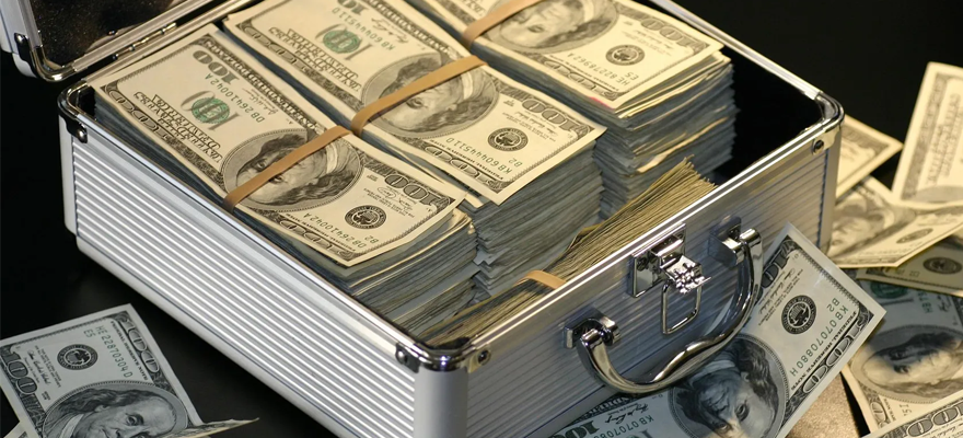 A cash box holds several stacks of hundred dollar bills without paying interest.