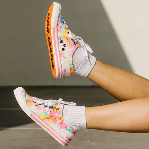 A pair of high-top sneakers with a colorful tie-dye pattern.