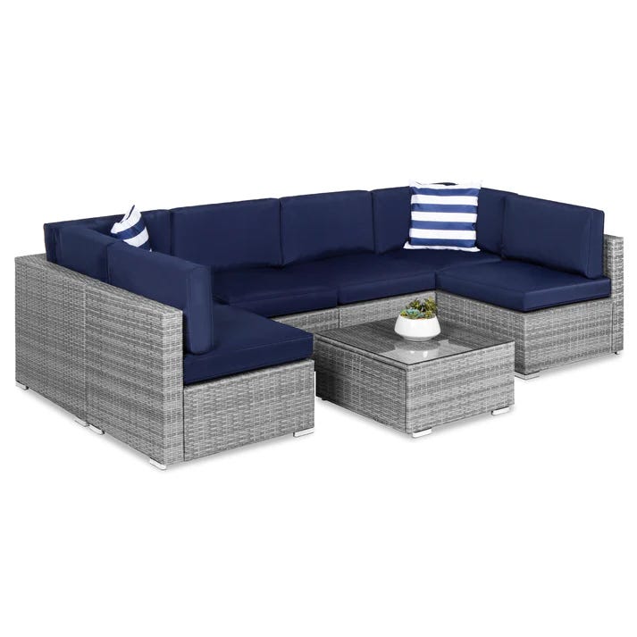 Outdoor sectional sofa set with deep blue cushions and a matching square coffee table, featuring a gray wicker design.