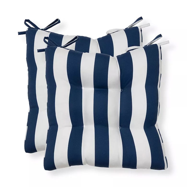 Two navy and white striped tufted chair cushions with ties for attachment.