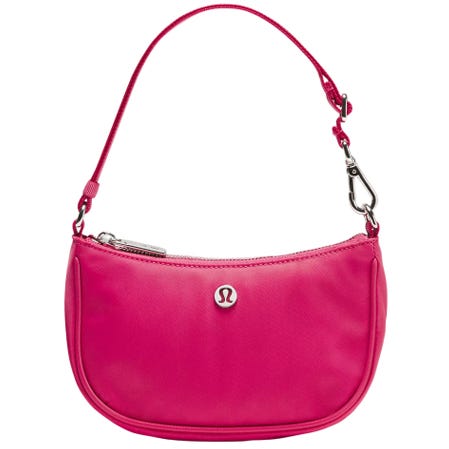 Pink shoulder bag with a silver logo, featuring a detachable strap and zipper closure.