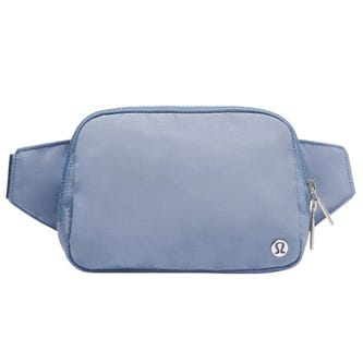 A light blue belt bag with a small Lululemon logo, featuring two zippers and an adjustable strap.
