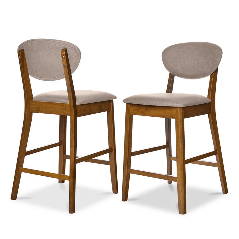 Two wooden bar stools feature padded seats and backs upholstered in beige fabric, with a warm brown finish on the frame. They have a mid-century modern design with sturdy legs and a footrest.