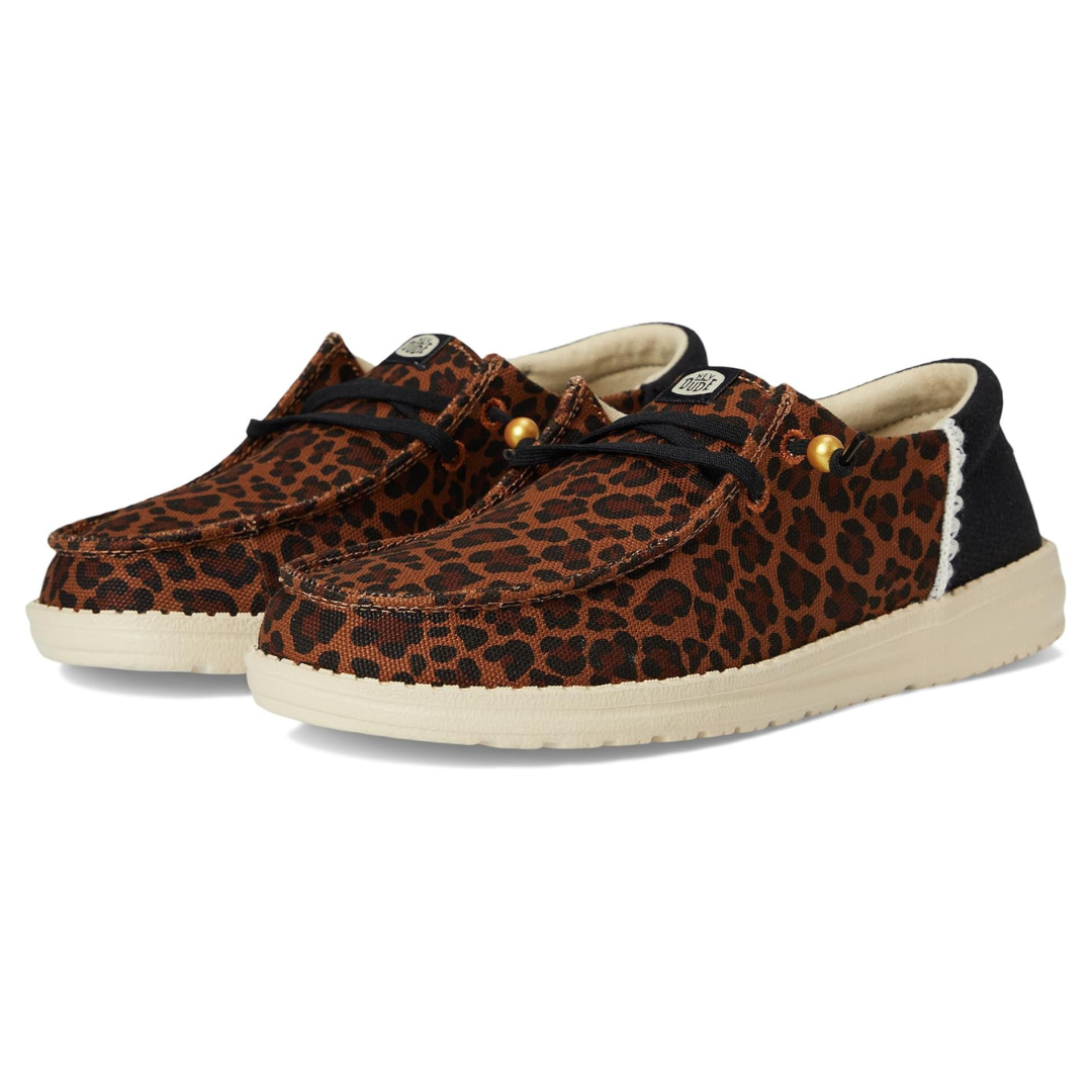 Casual shoes with a leopard print pattern, featuring black laces, light-colored soles, and a branded tag on the tongue.