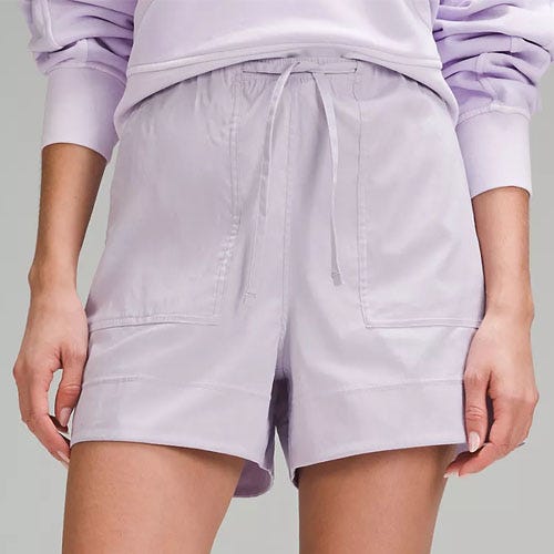 A pair of light purple drawstring shorts with side pockets.