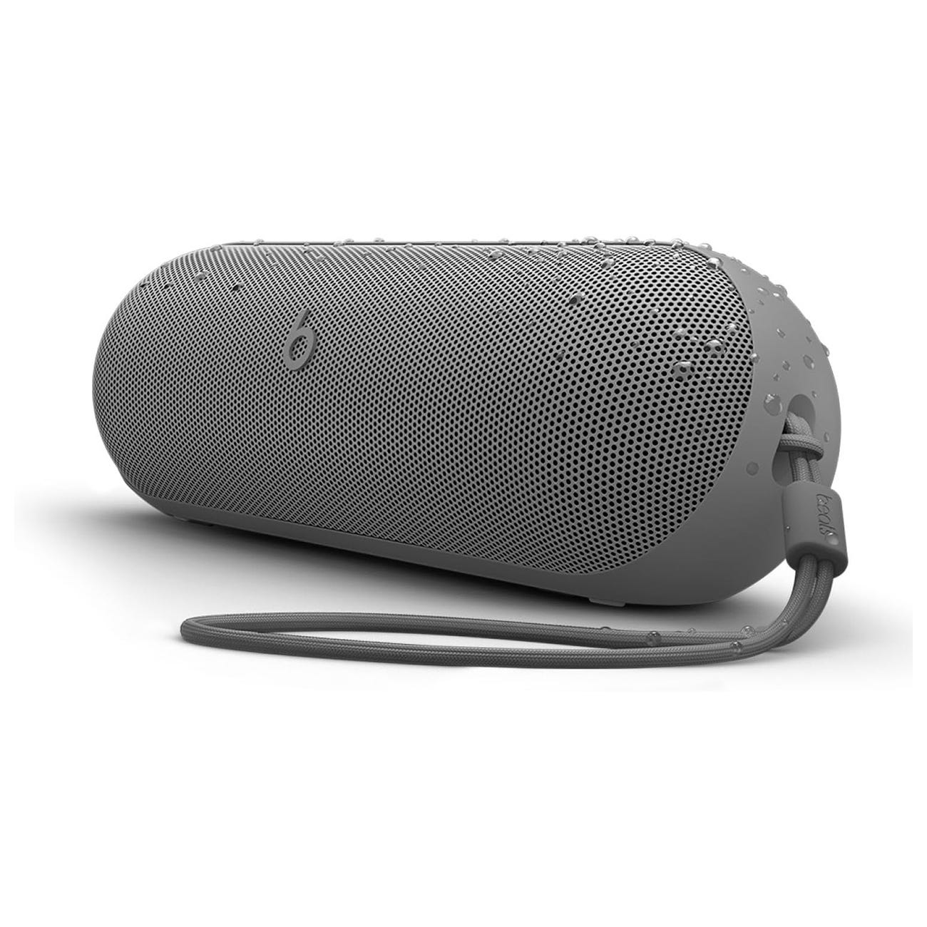A gray cylindrical Bluetooth speaker with a textured grill, water droplets, and a carrying strap.