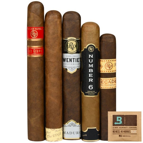 A selection of five cigars from the Rocky Patel brand, featuring various editions such as Sun Grown, The Edge, Twentieth Anniversary, Number 6, and Decade, accompanied by a Boveda humidity control pack.