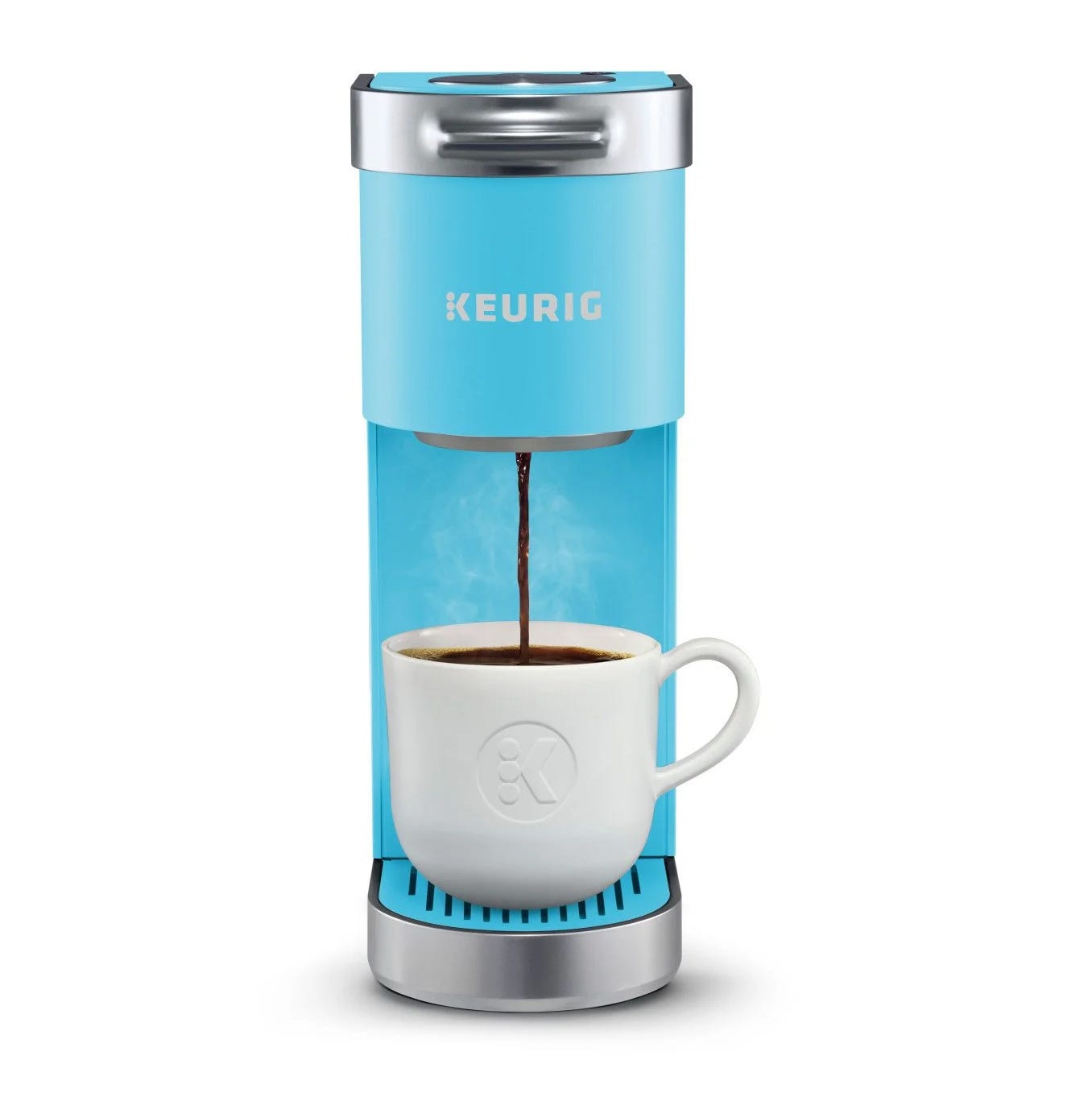 A blue Keurig coffee maker brews coffee into a white mug.
