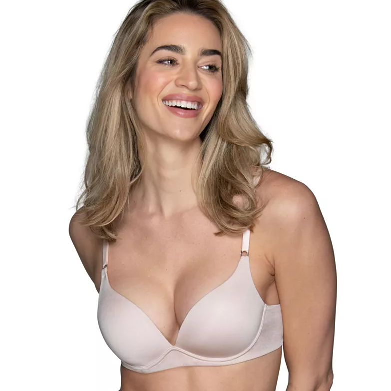 A woman smiling while wearing a light pink bra.