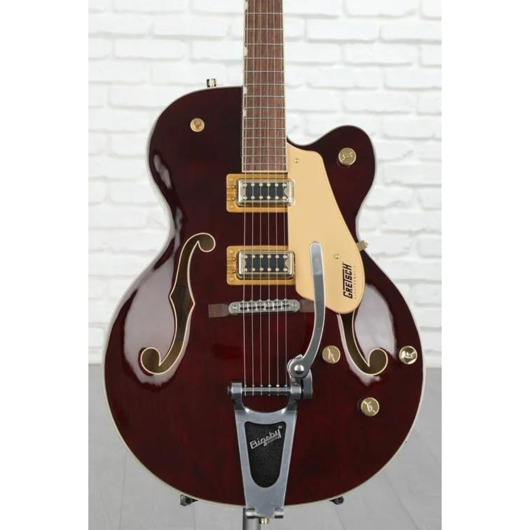 This is a Gretsch electric guitar with a dark finish, f-holes, two Filter'Tron pickups, a Bigsby tremolo, and gold-colored hardware.
