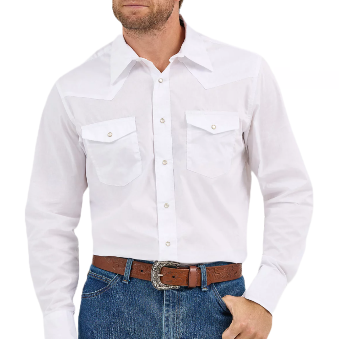 A classic white Wrangler Western Snap Shirt featuring pearl snap buttons, two chest pockets with flaps, and a pointed yoke design on the chest and back. It's paired with blue jeans and a brown leather belt with a decorative silver buckle.