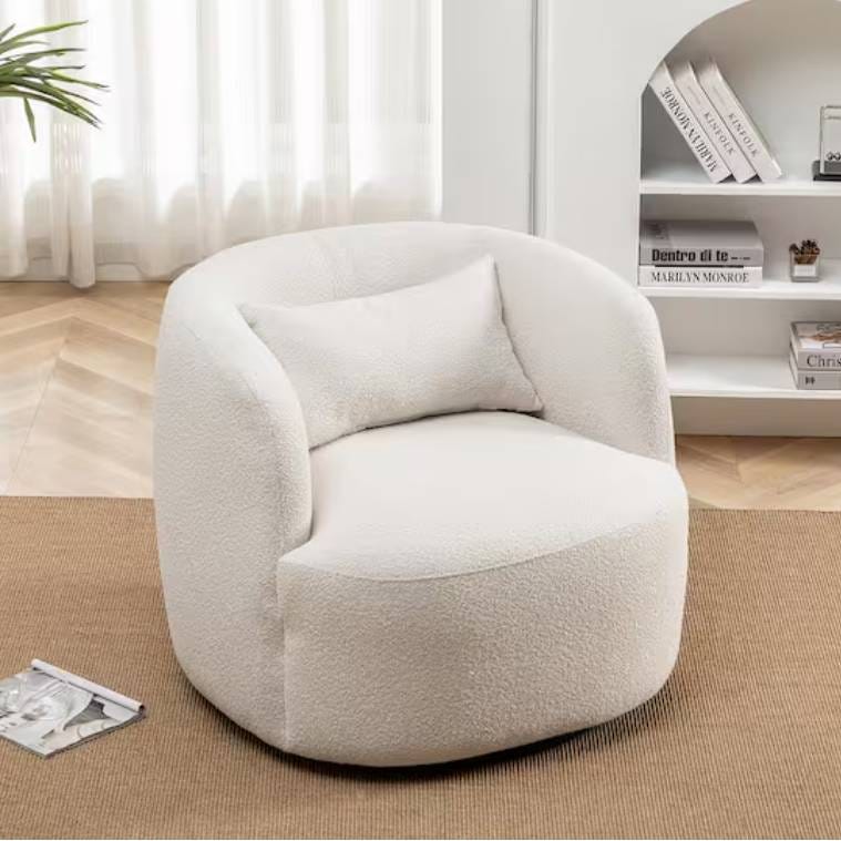 A plush, white round chair set against a light, modern living room backdrop with a bookshelf.