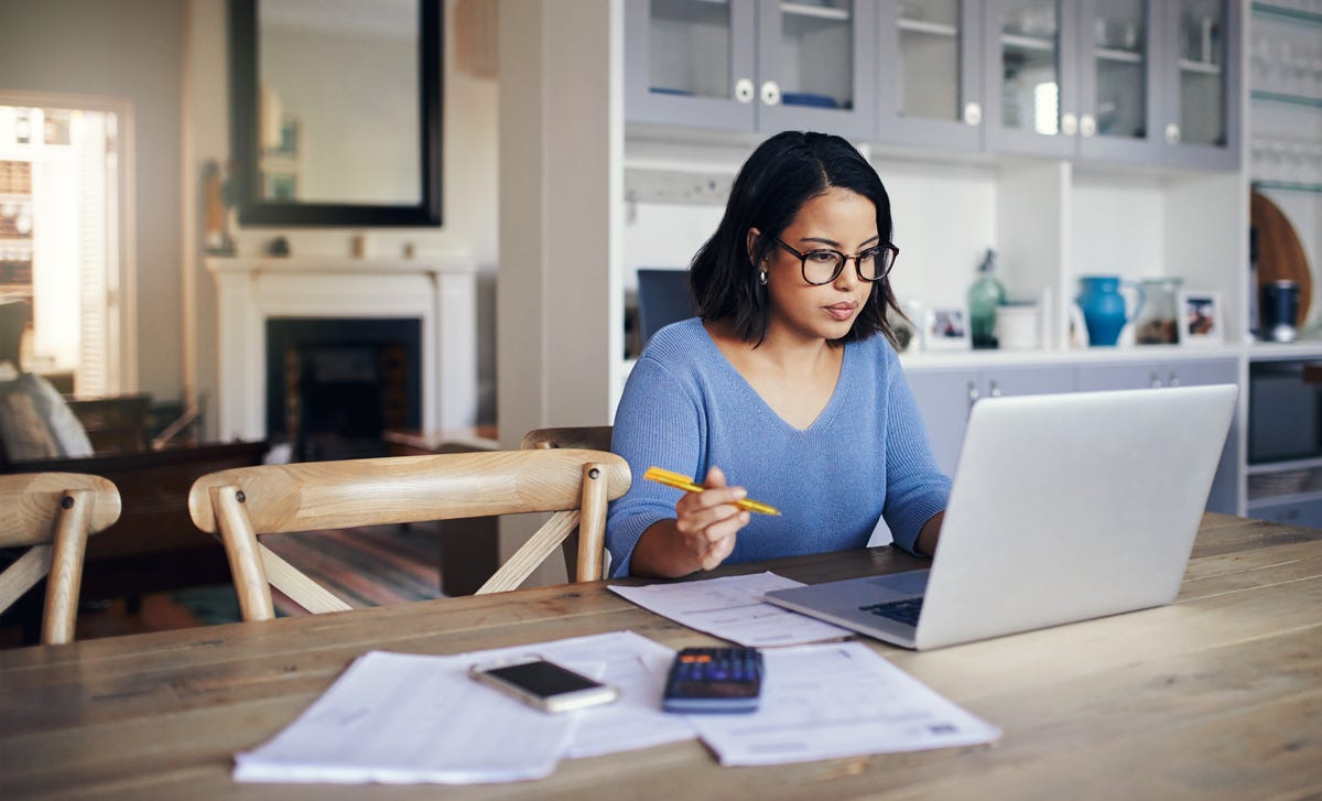 Woman holding a pen and reading the Imprint on Berlitz Nicaragua's website.