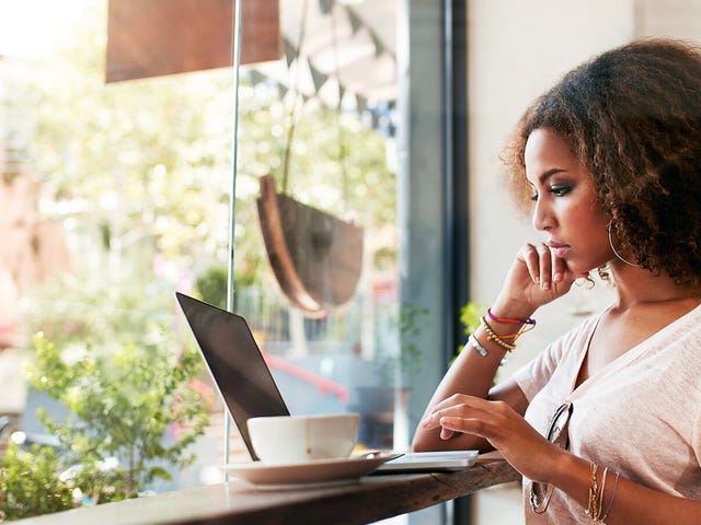 Woman in front of a window learning a language online on her laptop with Berlitz Nicaragua