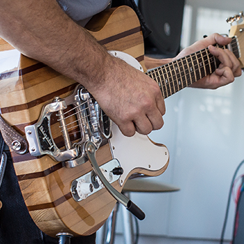 side shot of guitar made of salvaged wood