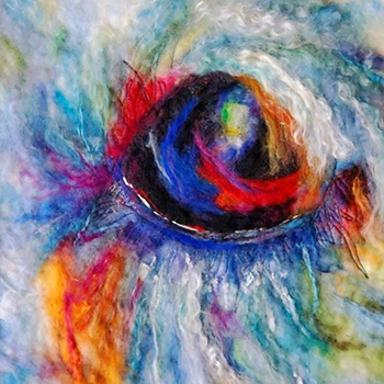 An iris created by Madeline Phuong with felted wool in a rainbow of colors.