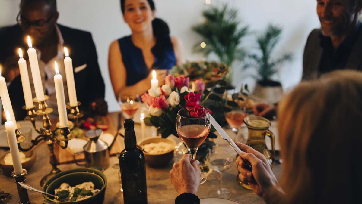 A dinner party with wine and food on a decorated table