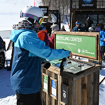 A WinterFest participant uses the Recycling Center at WinterFest.