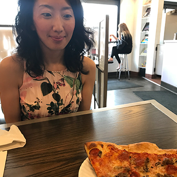 Kwon with a slice from Hello Pizza