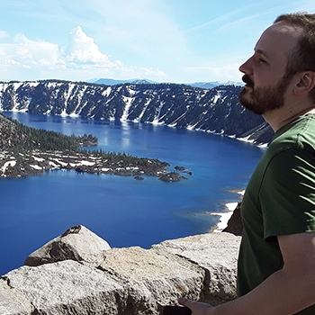 J.R. Wilhite’s son, Nick, standing at a scenic viewpoint overlooking Crater Lake in Crater Lake National Park in Oregon.