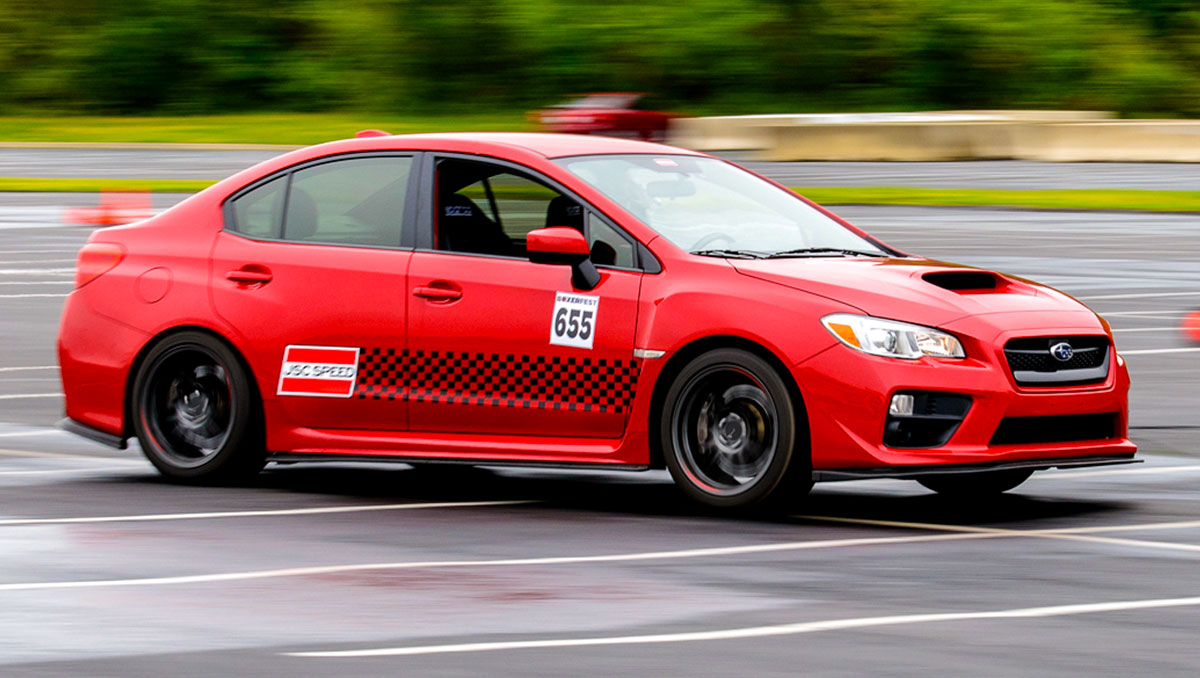 A Subaru WRX on a race track with an amateur driver at a track day