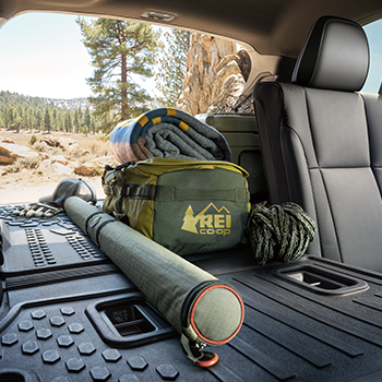 Shot of the Subaru Outback Wilderness vehicle's cargo area with an REI Co-op bag, blanket and other items stored securely.