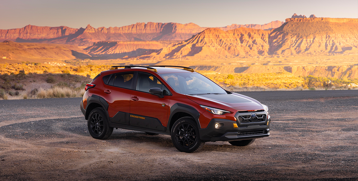 2024 Subaru Crosstrek Wilderness with mountains in the background and a kayak on the roof rack