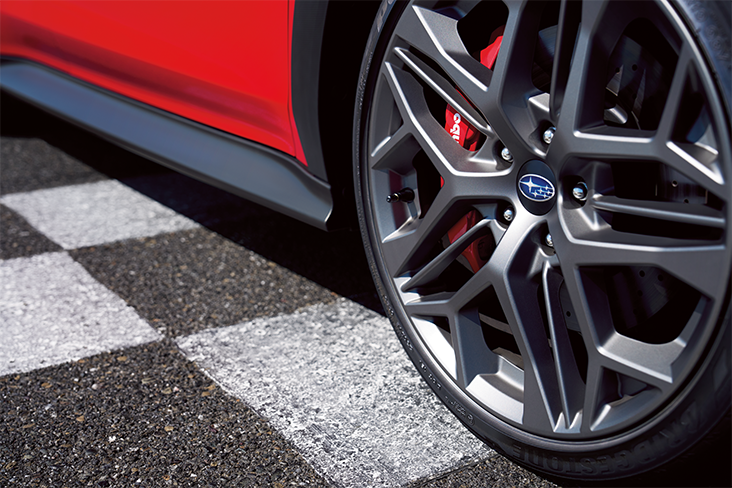 Closeup of a Subaru WRX TR wheel on checkered asphalt