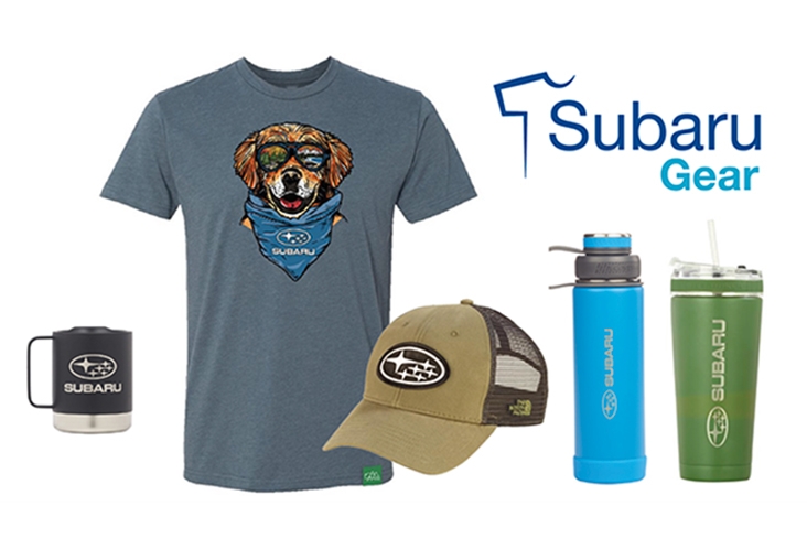 Five Subaru Gear items. A coffee cup with lid, light-blue T-shirt, tan-colored cap, aqua-blue water bottle and green thermos.