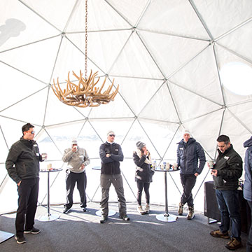 Instructors and students taking a break in the geodestic yurt to warm up.