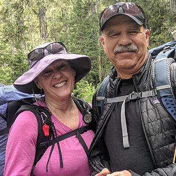 Donna and Jeff Saufley standing side by side in hiking gear.