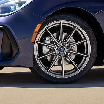 Close-up of an 18-inch, 10-spoke alloy wheel on the front end of a 2025 Subaru BRZ Series.Purple