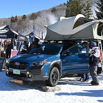 A Subaru Outback with a rooftop tent on display at WinterFest
