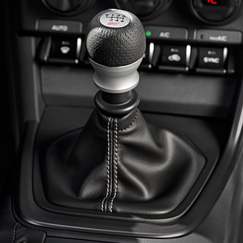 Close-up of aluminum shifter knob and shifter boot with gray stitching in the 2025 Subaru BRZ Series.Purple