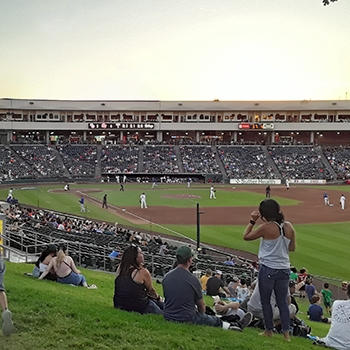A left outfield view of a baseball field full of spectators watching a minor league baseball game in Sacramento, California.