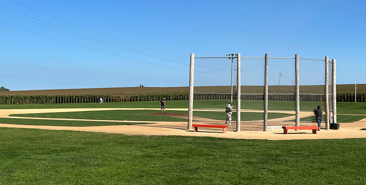 The backstop and baseball players at the Field of Dreams in Dyersville, Iowa