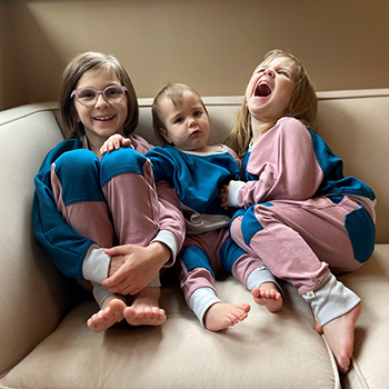 The three Bergmann girls, Lola, Percy and Harper, are wearing matching outfits from Peace House Studio.