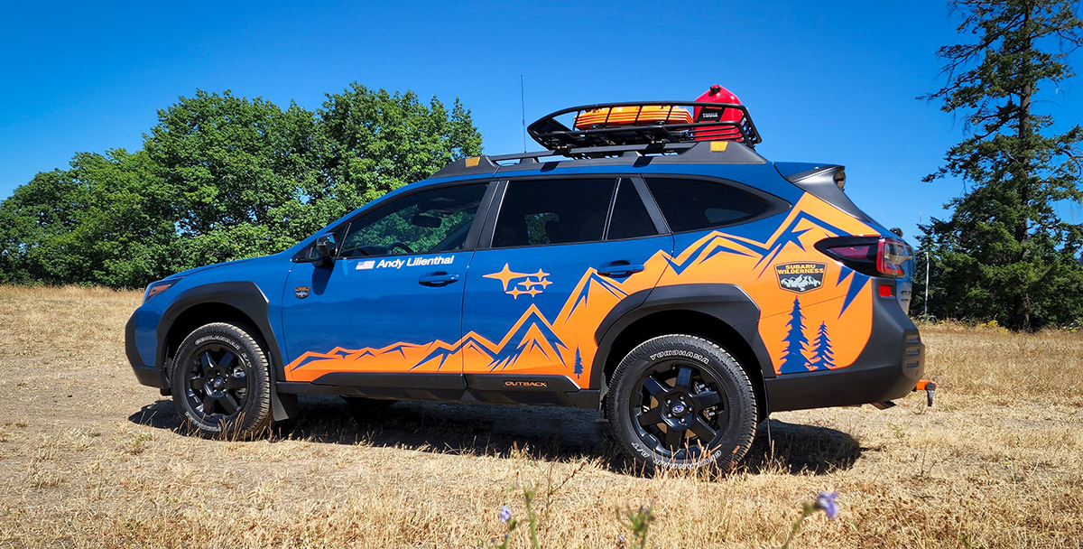 A Subaru Outback Wilderness featuring a rooftop basket and other modifications to take on the Alcan 5000